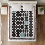 Barro Abstract Cotton Blend Blanket Throw in Teal, Black and Off-White, on a bed