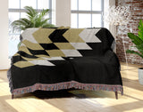Bimisii Southwestern Cotton Blend Blanket Throw in Black, Off-White and Dull Gold, draped over a chair