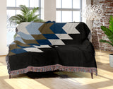Bimisii Southwestern Cotton Blend Blanket Throw in Blue, Brown, Black and Off-White, draped over a chair