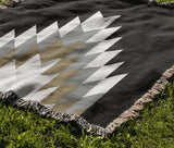 Bimisii Southwestern Cotton Blend Blanket Throw in Gray, Brown and Off-White, draped over a chair