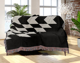 Bimisii Southwestern Cotton Blend Blanket Throw in Black and Off-White, draped over a chair