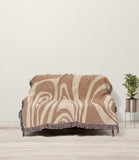 Binitie Zebra Print Cotton Throw Blanket in Rust and Beige, draped over a sofa