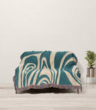 Binitie Zebra Print Cotton Throw Blanket in Teal and Beige, draped over a sofa