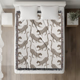 Bolt Leopard Cotton Blend Blanket Throw in Beige and Off-White, on a bed
