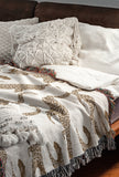 Bolt Leopard Cotton Blend Blanket Throw in Beige and Off-White, draped over a chair