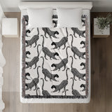Bolt Leopard Cotton Blend Blanket Throw in Black and Off-White, on a bed