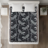 Bolt Leopard Cotton Blend Blanket Throw in Blue and Blue Gray, on a bed