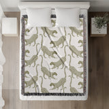Bolt Leopard Cotton Blend Blanket Throw in Chartreuse and Off-White, on a bed