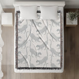 Bolt Leopard Cotton Blend Blanket Throw in Light Gray and Off-White, on a bed
