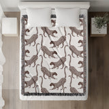 Bolt Leopard Cotton Blend Blanket Throw in Rust Brown and Off-White, on a bed