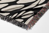Buga Abstract Print Cotton Throw Blanket in Black and Beige, side view