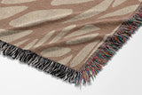 Buga Abstract Print Cotton Throw Blanket in Rust and Beige, side view