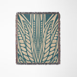 Buga Abstract Print Cotton Throw Blanket in Teal and Beige, laid flat