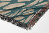 Buga Abstract Print Cotton Throw Blanket in Teal and Beige, side view