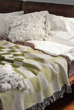 Bullseye Abstract Cotton Blend Blanket Throw in Chartreuse and Off-White, draped over a chair