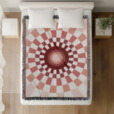 Bullseye Abstract Cotton Blend Blanket Throw in Red and Off-White, on a bed