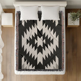 Caca Southwestern Cotton Blend Blanket Throw in Black and Off-White, on a bed