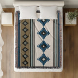 Carlos Southwestern Cotton Blend Blanket Throw in Blue, Black, Dull Gold and Off-White, on a bed