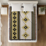 Carlos Southwestern Cotton Blend Blanket Throw in Black, Dull Gold and Off-White, on a bed