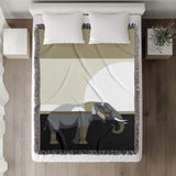 Carney Elephant Cotton Blend Blanket Throw in Black, Gray and Gold, on a bed