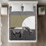 Carney Elephant Cotton Blend Blanket Throw in Gray and Gold, on a bed