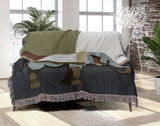 Carney Elephant Cotton Blend Blanket Throw in Blue, Gray and Chartreuse, draped over a chair