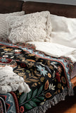 Cece Elephant Cotton Blend Blanket Throw in Black, Beige, Blue and Red, on a bed