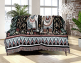 Cece Elephant Cotton Blend Blanket Throw in Black, Beige, Blue and Red, draped over a chair