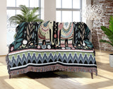 Cece Elephant Cotton Blend Blanket Throw in Black, Green and Yellow, draped over a chair