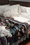 Cece Elephant Cotton Blend Blanket Throw in Black, Blue and Red, on a bed