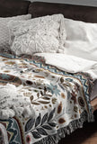 Cece Elephant Cotton Blend Blanket Throw in Beige, Blue and Off-White, on a bed