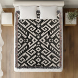 Chitto Southwestern Cotton Blend Blanket Throw in Black and Off-White, on a bed