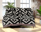 Chitto Southwestern Cotton Blend Blanket Throw in Black and Off-White, draped over a chair