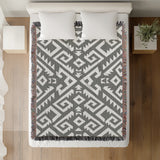 Chitto Southwestern Cotton Blend Blanket Throw in Gray and Off-White, on a bed
