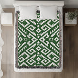 Chitto Southwestern Cotton Blend Blanket Throw in Green and Off-White, on a bed