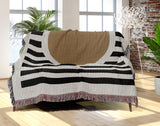 Circle Abstract Cotton Blend Blanket Throw in Beige, Black and Off-White, draped over a chair