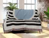 Circle Abstract Cotton Blend Blanket Throw in Blue, Black and Off-White, draped over a chair