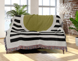 Circle Abstract Cotton Blend Blanket Throw in Black, Chartreuse and Off-White, draped over a chair