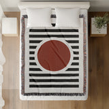 Circle Abstract Cotton Blend Blanket Throw in Red, Black and Off-White, on a bed