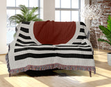 Circle Abstract Cotton Blend Blanket Throw in Red, Black and Off-White, draped over a chair