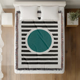 Circle Abstract Cotton Blend Blanket Throw in Teal, Black and Off-White, on a bed