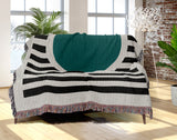 Circle Abstract Cotton Blend Blanket Throw in Teal, Black and Off-White, draped over a chair