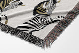Ciro Zebra Cotton Blend Blanket Throw in Black and Off-White, draped over a chair
