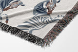 Ciro Zebra Cotton Blend Blanket Throw in Blue and Off-White, draped over a chair