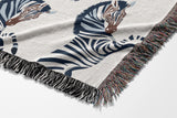 Ciro Zebra Cotton Blend Blanket Throw in Dark Blue and Off-White, draped over a chair