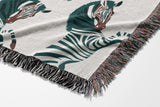 Ciro Zebra Cotton Blend Blanket Throw in Teal and Off-White, draped over a chair