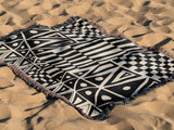 Cocodili Abstract Print Cotton Throw Blanket in Black and Beige, outdoors