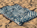Cocodili Abstract Print Cotton Throw Blanket in Blue and Beige, outdoors