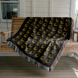 Cube Cotton Blend Blanket Throw in Black, draped over a chair