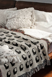 Cube Cotton Blend Blanket Throw in White, on a bed